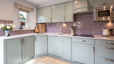 There is an oven and hob, microwave, coffee machine, fridge/freezer, kettle and toaster. Hidden