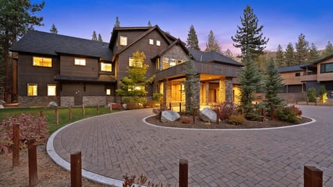 Exterior: Front entrance with covered portico, circular driveway, landscaped grounds, on-site parking for 10 vehicles (2 in garage, 8 in driveway)
