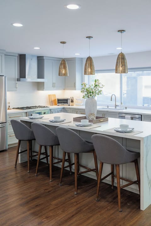 Kitchen features modern appliances and a breakfast bar.