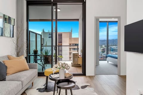 Bright living space opening onto a city-view balcony.