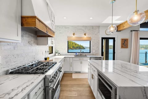 Chef’s kitchen with breathtaking lake views — featuring professional-grade appliances, marble counters, and everything you need to cook, gather, and unwind