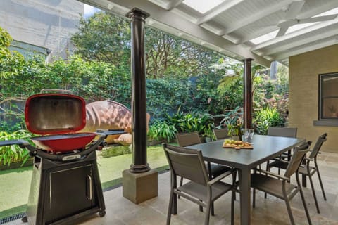 The spacious alfresco area opens directly onto the lush lawn and features a stylish outdoor setting with seating for up to six. Perfect for leisurely gatherings, it also includes a dedicated barbecue space for relaxed outdoor dining and entertaining.
