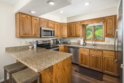 up to date kitchen with granite and stainless appliances