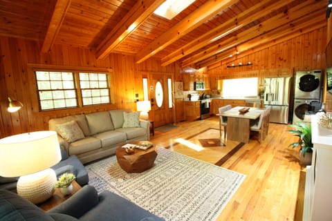 Vaulted ceilings with skylights span the living room and kitchen, creating a bright, open space filled with natural light—perfect for relaxing and enjoying time together.