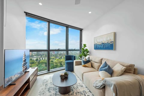 Elegant reflection view showcasing the Brisbane skyline and contemporary lounge setting.