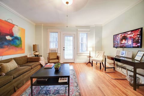Settle into the plush velvet sofa for an evening of relaxation in this sophisticated space.