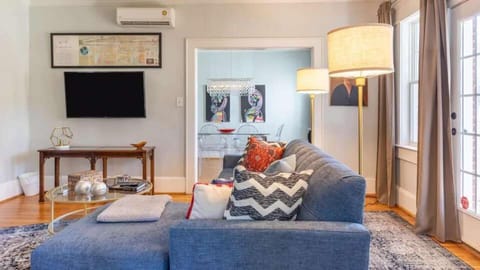Relax in this inviting living area with cozy seating, warm lighting, and a wall mounted TV for easy entertainment. The open layout creates a comfortable space to unwind.