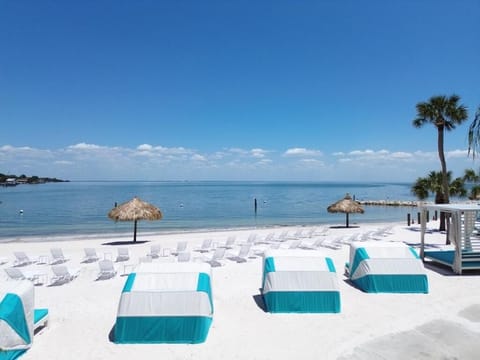 Lounge on bright white sand with breezy seaside calm.
