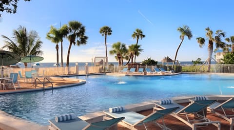 Dive into a sunlit pool with sweeping ocean views.