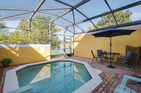 Enjoy a private screened pool area with outdoor seating and lake views.