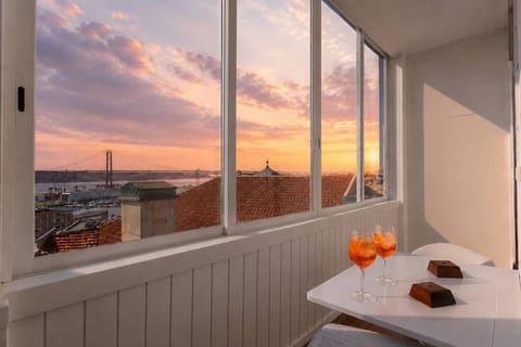 Panoramic Lisbon sunset views from the enclosed balcony • StayInLisbon