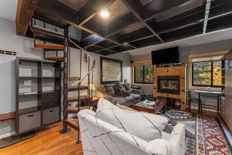 Cozy up by your fireplace with exposed beams overhead and spiral stairs leading to your loft retreat.