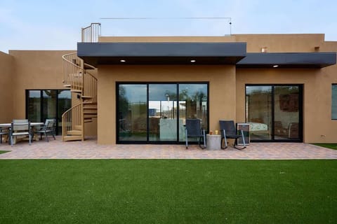 Stunning private oasis with private patio, outdoor dining table, mini fridge, and outdoor seating.