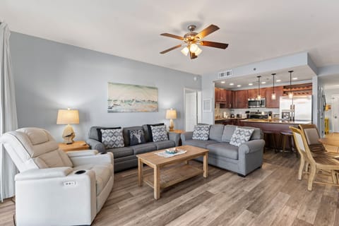 Spacious living room with modern seating and open kitchen for family gatherings.