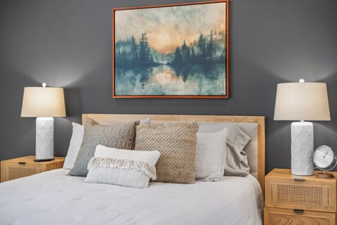 Beautifully decorated primary with quality linens for a restful night's sleep.