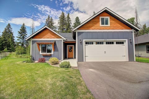 Charming mountain-style home with a spacious driveway and beautifully maintained landscaping, set in a peaceful Kalispell neighborhood.