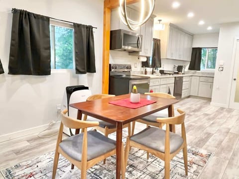 Enjoying effortless meals and easy conversation in this bright, open-concept dining space that flows right into the modern kitchen.
