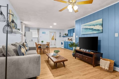 Bright and cozy living room with plush seating and a large TV for entertainment. Perfect for relaxing after a fun day out.