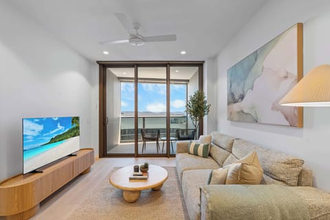 Bright and airy space featuring smart TV and seamless flow to the balcony