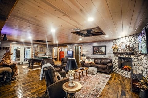 Living Room with Fireplace, Leather furniture, Hardwoods, next to Game Room.