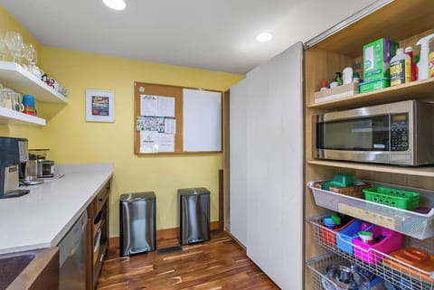 Microwave; Supply cabinet and trash/recycling.