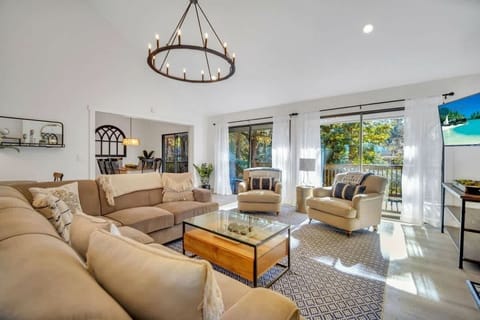 Bright living room with large windows and comfortable seating for relaxing.