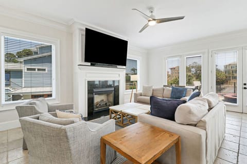 Bright living room with a fireplace and large windows offering natural light.