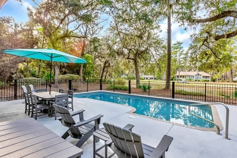 Soak up South Carolina sunshine in your private pool surrounded by majestic oak trees and Spanish moss—your perfect outdoor retreat awaits.