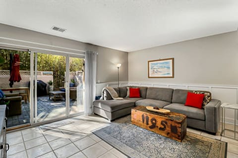 Cozy living room with a sectional sofa and sliding doors opening to a private patio.