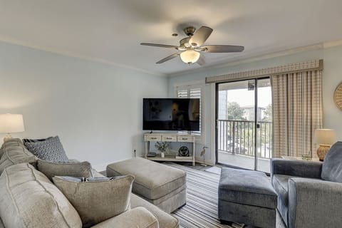 Relax in this modern living room with a balcony view and comfortable seating.
