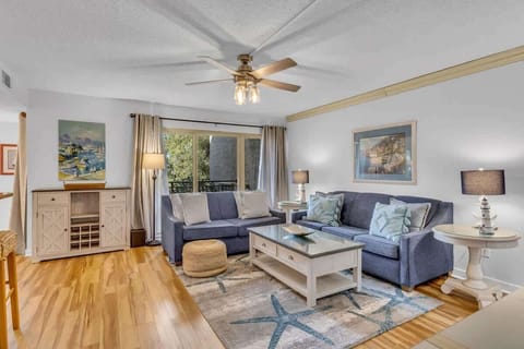 Relax in this coastal-inspired living room with comfortable seating and natural light.