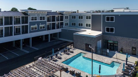 Stunning aerial view of the pool area, ample seating for sunbathing and fun