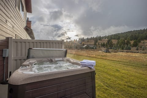 Soak in the relaxing hot tub under the stars after a long day in the mountains | Exterior