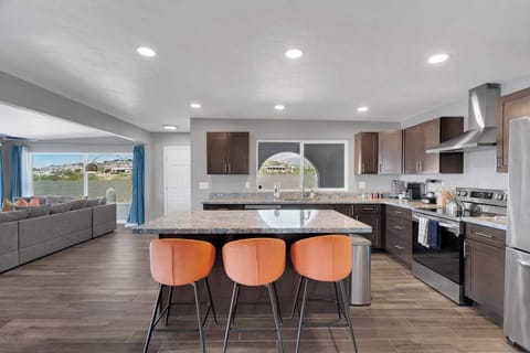 Gather around the inviting dining table with stylish chairs and soft lighting. A perfect spot for morning coffee, family meals, or a glass of wine at the end of the day.