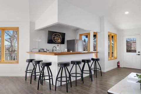 The top level game room has a kitchenette with a bar area and plenty of stools for seating.