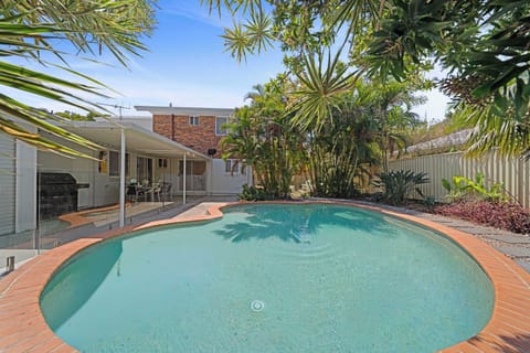 Poolside view connecting indoor living with outdoor fun.