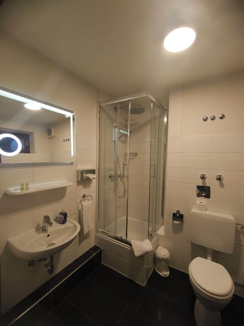 Shower, hair dryer, towels, toilet paper