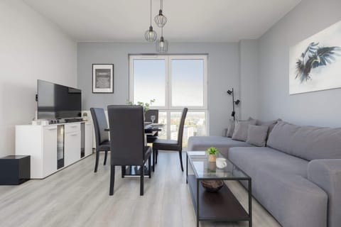 A spacious living room with a comfortable sofa and dining area – perfect for relaxing together.