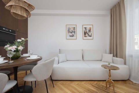 A bright interior with a soft sofa and a wooden table creates an inviting space to relax after a day of exploring the city.