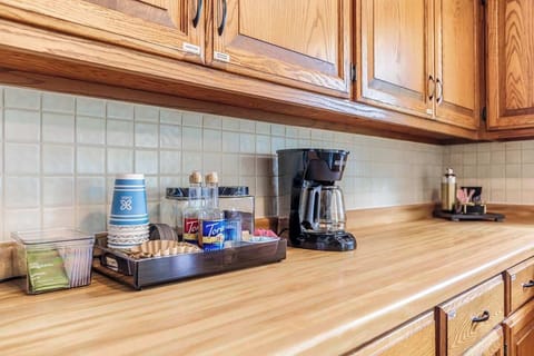 A cozy shot of the coffee station, fully stocked with everything you need to start your morning—coffee maker, mugs, filters, and a selection of coffee and tea essentials provided for your stay.