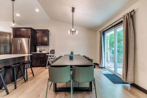 Gather around the spacious dining table that seats 10—perfect for group meals or game day feasts. Patio doors open to the backyard for indoor-outdoor entertaining at this modern home just 3 houses from Lambeau Field in Green Bay.