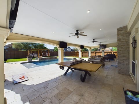 View of the Ping Pong Table, Outdoor patio, pool and fire pit area 