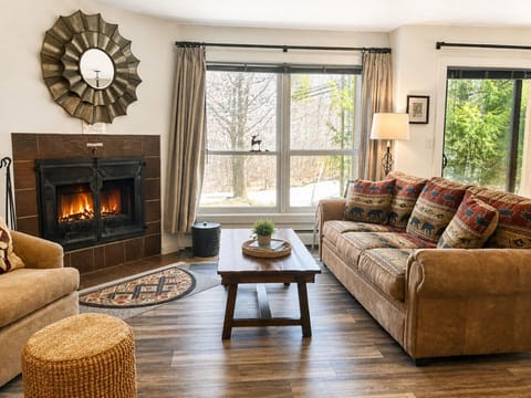 Cozy living room with a comfy couch and wood-burning fireplace.