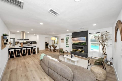 Bright, airy layout with bar seating, a family table, and easy access to the backyard.