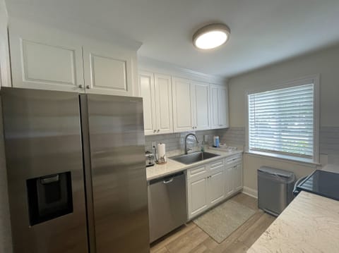 Renovated kitchen w/ a large fridge, blender, Keurig, and a drip coffee maker