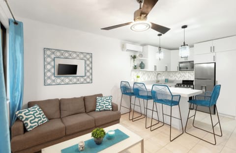 Beautiful open living space with a couch and TV to relax.