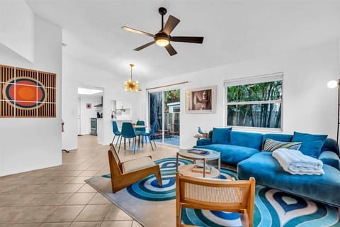 Step into nostalgia with this retro 70's living room where funky patterns and bold colors reign supreme. The colorful decor, vintage wood furnishings, and brand new velvety soft couch brings groovy retro vibes into the home!