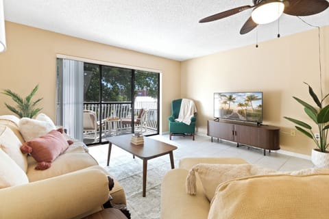 Bright & airy living room leads to sliding glass doors with private outdoor balcony