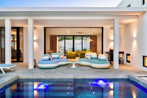 Fluid Elegance Pool Deck Showcasing the BOMBOM Outdoor Sofa
