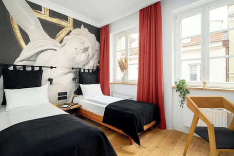 Relax in a beautifully designedac room with art-inspired décor and a refreshing touch of greenery.